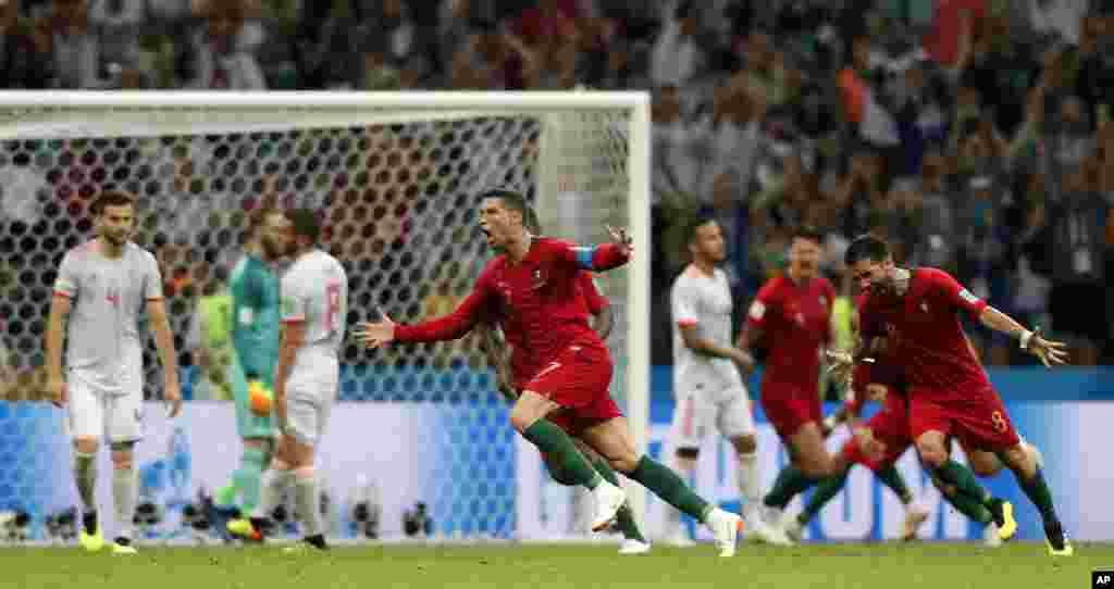 Portugal's Cristiano Ronaldo celebrates after he scored his third goal with a free kick during the group B match between Portugal and Spain at the 2018 soccer World Cup in the Fisht Stadium in Sochi, Russia.
