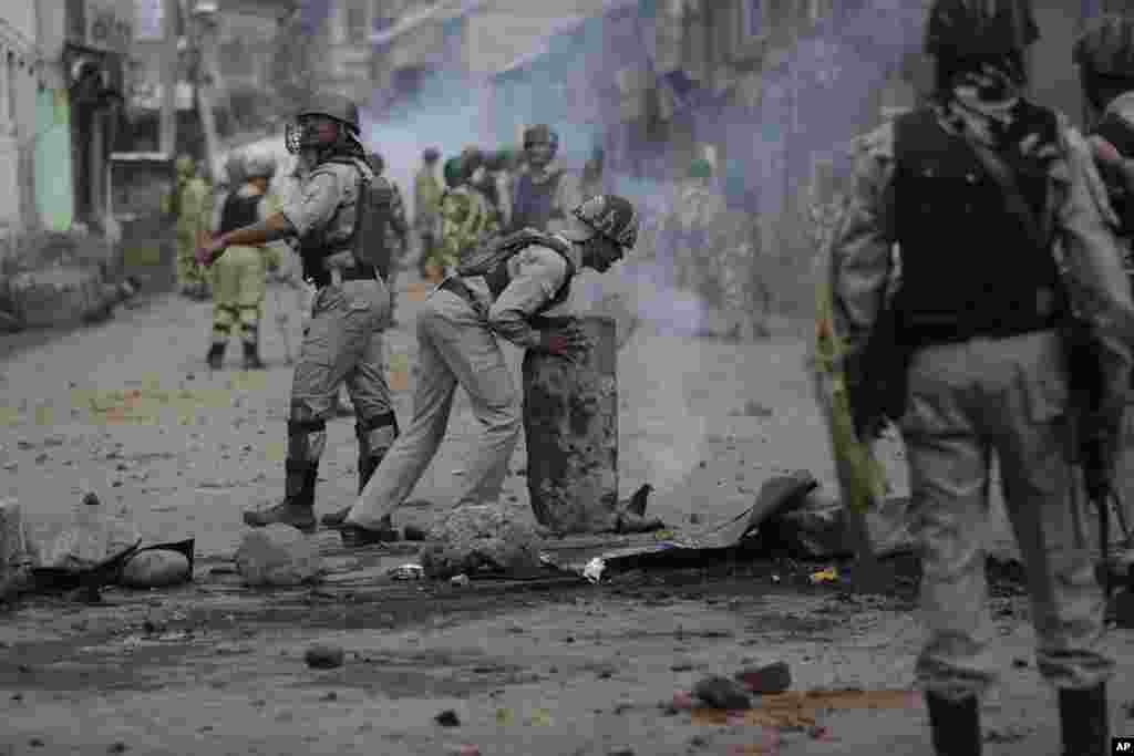 Indian government forces remove road blocks set by protesters during a clash after curfew was lifted in some parts of Srinagar in Indian-controlled Kashmir