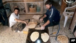 Syrian rebels make bread in the town of Qusair, Homs province, Syria. The UN is stepping up food deliveries in Syria ahead of the early July start of the Islamic holy month of Ramadan, June 3, 2013.