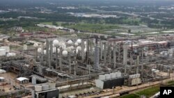 This aerial photo shows the TPC petrochemical plant near downtown Houston, background, on Tuesday, Aug. 29, 2017.