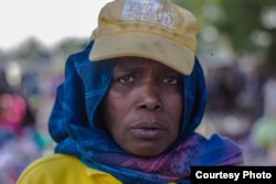 Hajja Hauwa, one of the few females in the vigilante group in Maiduguri, is in charge of security checks for women coming into Monday market, Maiduguri. (Fati Abubakar)