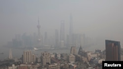FILE - The financial district of Pudong is seen on a hazy day in Shanghai, March 18, 2014.