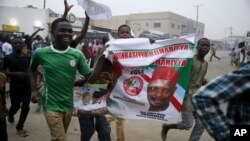 People celebrate after news that Muhammadu Buhari appeared to have won Nigeria's presidential election, in Kano, March 31, 2015.