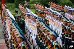 Members of the honor guard prepare for the arrival of France's President Francois Hollande at the Presidential Palace in Hanoi, Vietnam, Sept. 6, 2016.