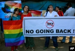 FILE - A group of Indian activists hold a banner against section 377 of the Indian Penal Code that criminalizes homosexuality during a protest in Mumbai, India, Dec. 11, 2013.
