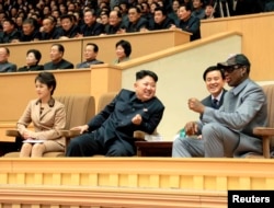 FILE - North Korean leader Kim Jong Un, second from left, watches a basketball game between former U.S. NBA basketball players and North Korean players of the Hwaebul team of the DPRK with Dennis Rodman, right. Analysts say Kim sometimes acts like an impatient coach in managing his advisers.