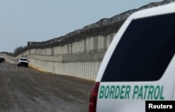 FILE - U.S. Border Patrol vehicles are patrol along the U.S. Mexico border area in San Diego, California, April 21, 2017.