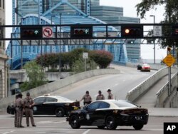 Florida Highway patrolmen block the entrance to the Main Street Bridge near the scene of a mass shooting at Jacksonville Landing in Jacksonville, Fla., Sunday, Aug. 26, 2018.