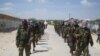 FILE - Members of Somalia's al-Shabab militant group march on the outskirts of Mogadishu, Somalia, March, 5, 2012. 