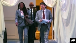 FILE - President of IAAF (International Amateur Athletic Federation) Sebastian Coe, right, with President of USA Track & Field (USATF) Stephanie Hightower, left, followed by Frank Fredericks, centre, member of the International Olympic Committee, as they arrive to a press conference after the 202nd IAAF Council Meeting in Monaco, Nov. 26, 2015