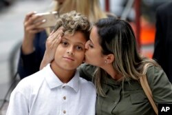 Sirley Silveira Paixao, an immigrant from Brazil seeking asylum, kisses her 10-year-old son Diego Magalhaes after he was released from immigration detention in Chicago, July 5, 2018.