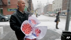 File -- John Wickersham bunches of roses he bought on New York's Upper West Side on Valentine's Day.
