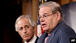 Senate Foreign Relations Committee Chairman Sen. Robert Menendez and the committee's ranking member, Sen. Bob Corker hold a news conference on Capitol Hill in Washington, March 27, 2014, after the Senate passed the Ukraine Aid Bill.