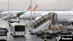 FILE - Air Cote d'Ivoire planes are seen at Felix Houphouet Boigny International airport, in Abidjan, Cote d' Ivoire, June 26, 2020. 