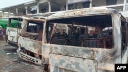 FILE - Burned buses are seen at the bus terminal in Buea, Cameroon, July 10, 2018. Gunfire broke out in the capital of a western region of Cameroon gripped by violence between anglophone separatists and security forces.