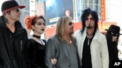 De izquierda a derecha, Tommy Lee, una mujer no identificada, Vince Neil, Nikki Sixx y Mick Mars, miembros del grupo Motley Crue.