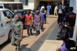 FILE - Men arrested in connection with Cameroon's anglophone crisis are seen at the military court in Yaounde, Cameroon, Dec. 14, 2018.