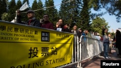 FILE - People line-up in front of polling station to vote during a civil referendum held by the Occupy Central organizers in Hong Kong January 1, 2014. 