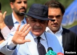 FILE - Shahbaz Sharif, chief minister of Punjab Province and brother of Pakistan's former Prime Minister Nawaz Sharif, gestures after appearing before a Joint Investigation Team in Islamabad, Pakistan, June 17, 2017.