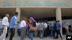  Egyptian journalists wait for information about tourists who were injured Sunday while on a desert safari trip, in front of the Dar Al Fouad Hospital in Cairo, Egypt, Sept. 14, 2015.