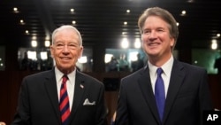 Supreme Court nominee Brett Kavanaugh, standing with Senate Judiciary Chairman Chuck Grassley, R-Iowa, arrives at the Senate Judiciary Committee on Capitol Hill, Sept. 4, 2018, in Washington, to begin his confirmation hearing to replace retired Justice Anthony Kennedy.