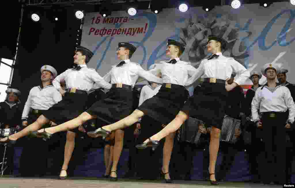 Members of the Russian Song and Dance Ensemble of the Black Sea Fleet perform during a pro-Russian rally in Simferopol, Crimea, March 9, 2014. 