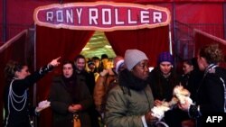 Homeless and needy people arrive at the Rony Roller Circus in Rome after Pope Francis invited them to enjoy the show, Jan. 14, 2016.