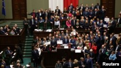 Polish opposition parliamentarians protest against the rules proposed by the head office of the lower house of parliament that would ban all recording of parliamentary sessions except by five selected television stations and limits the number of journalists allowed in building.