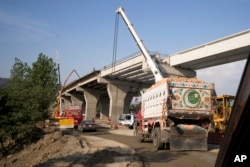 FILE - Work in progress at a new international trade route near Havalian in Pakistan, Thursday, May 11, 2017. The work is part of a sprawling Chinese initiative to build a "new Silk Road" of ports, railways and roads to expand trade in a vast arc of countries across Asia, Africa and Europe.