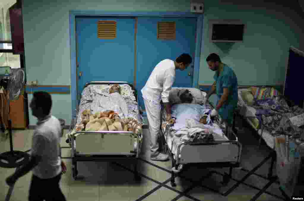 Patients lie in their beds on the ground floor of al-Wafa rehabilitation hospital after being evacuated from the fourth floor, which police said was hit by a tank shell fired by Israeli troops, in the east of Gaza City July 16, 2014.