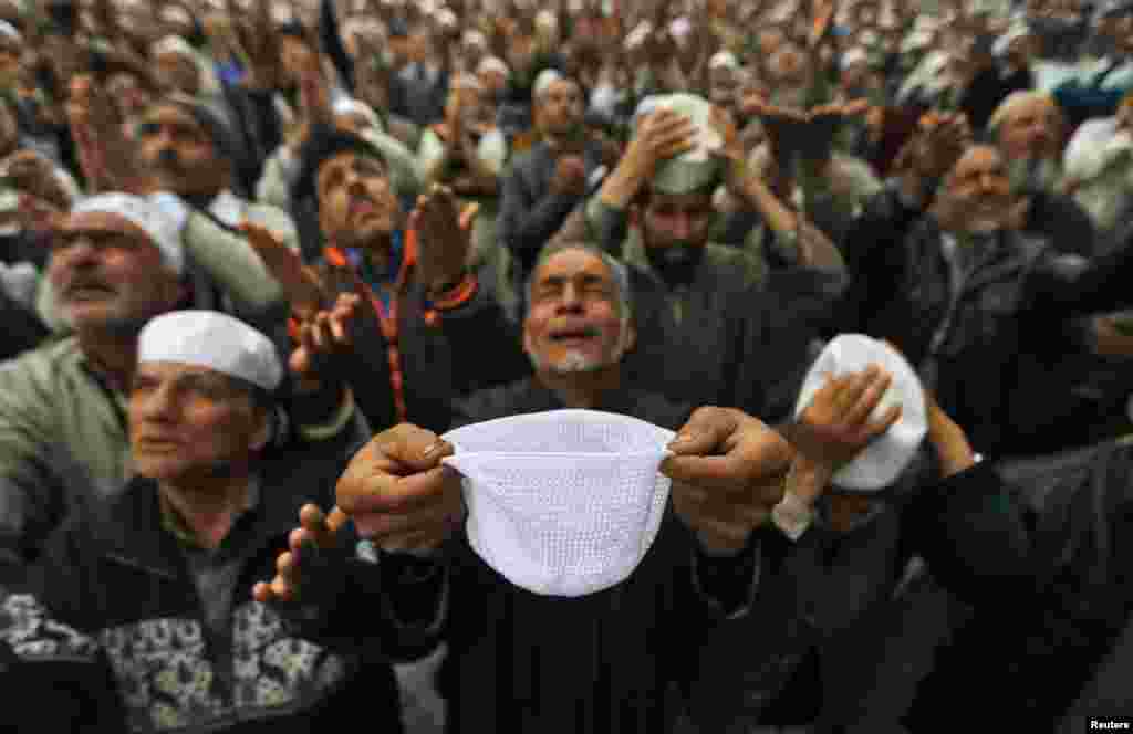 Kashmiri Muslims cry as they pray upon seeing a relic believed to be hair from the beard of Prophet Mohammed during a festival to mark the death anniversary of Abu Bakr, one of the companions of Prophet Mohammad, at the Hazratbal shrine in Srinagar, Indian-controlled Kashmir.