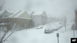 Vehicles are left in snowbanks in Fairfax City, Virginia, as major snowstorm hits the Atlantic Coast of the United States, 19 Dec 2009