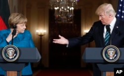 FILE - President Donald Trump and German Chancellor Angela Merkel participate in a joint news conference in the East Room of the White House in Washington, March 17, 2017.