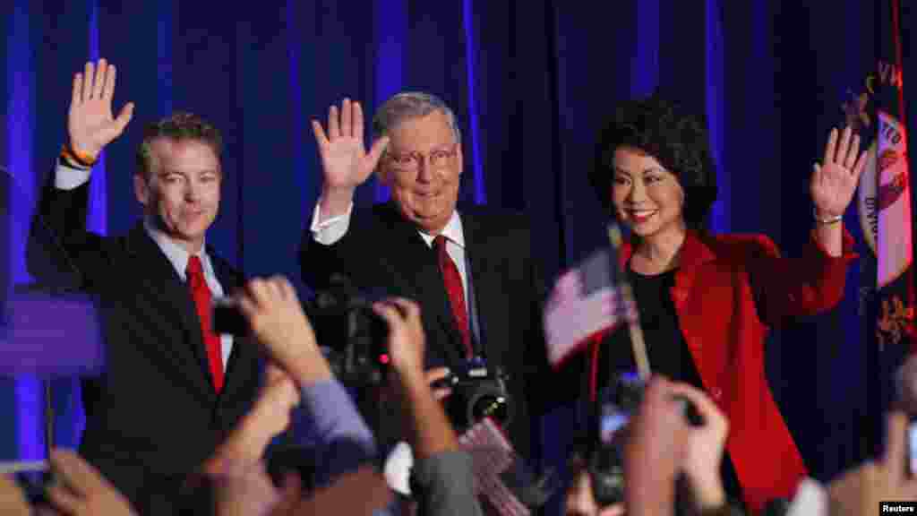 From left, U.S. Republican Senator Rand Paul from Kentucky, Senate Minority Leader Mitch McConnell, McConnell's wife, former U.S. Secretary of Labor, Elaine Chao, celebrate at McConnell's midterm election night victory rally in Louisville, Kentucky, Nov. 