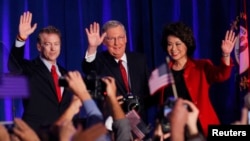 From left, U.S. Republican Senator Rand Paul from Kentucky, Senate Minority Leader Mitch McConnell, McConnell's wife, former U.S. Secretary of Labor, Elaine Chao, celebrate at McConnell's midterm election night victory rally in Louisville, Kentucky, Nov. 