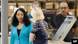 Palm Beach County Supervisor Of Elections Susan Bucher, left, speaks to employees before starting a recount at the Supervisor of Elections office, Nov. 15, 2018, in West Palm Beach, Florida.