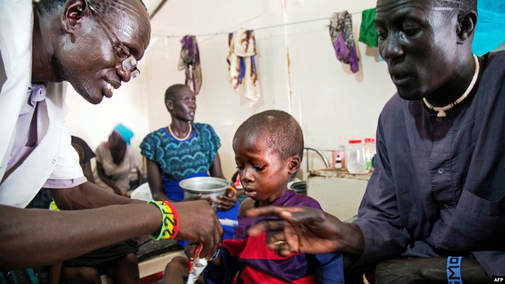 A medical officer from Doctors Without Borders (MSF) attends to a child with malnutrition in a clinic in Old Fangak, Jonglei state, on Aug. 18, 2017. 