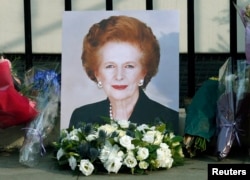 A portrait left by mourners is seen outside the home of former British Prime Minister Margaret Thatcher after her death was announced in London, April 8, 2013.