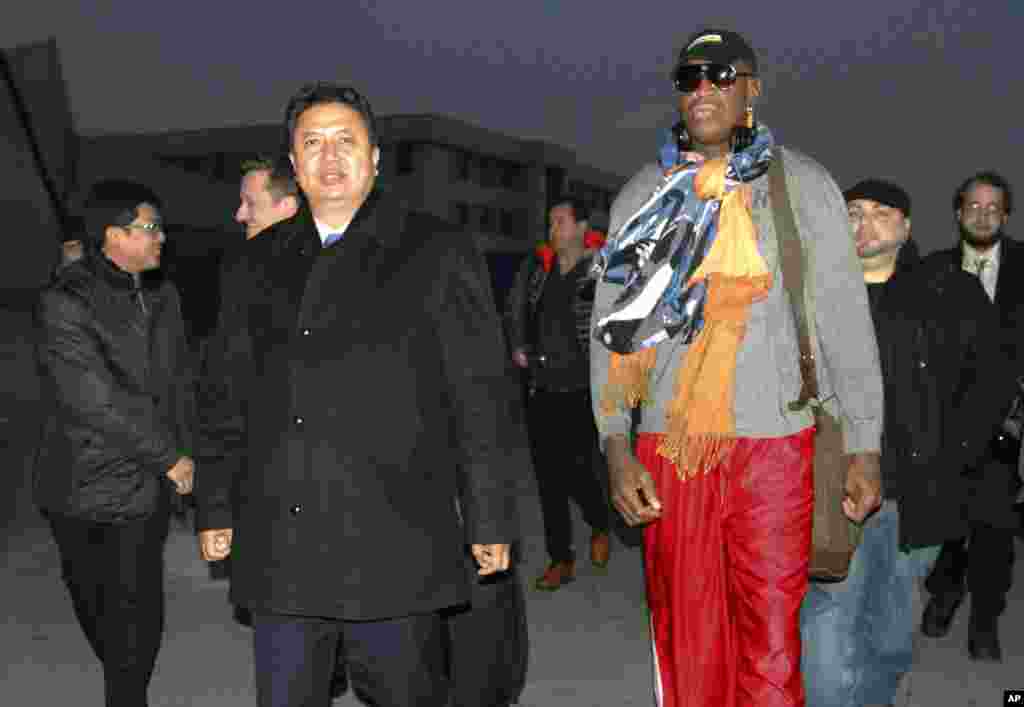 Former NBA basketball star Dennis Rodman, right, walks with Vice Minister of North Korea&#39;s Sports Ministry, Son Kwang Ho, as Rodman arrives at the international airport in Pyongyang, North Korea, Dec. 19, 2013.