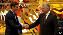 FILE - Spain's Prime Minister Pedro Sanchez, left, and Cuba's President Miguel Diaz-Canel shake hands at the Palace of The Revolution in Havana, Cuba, Nov. 22, 2018. 