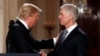 President Donald Trump shakes hands with 10th U.S. Circuit Court of Appeals Judge Neil Gorsuch, his choice for Supreme Court associate justice in the East Room of the White House in Washington, Tuesday, Jan. 31, 2017. 
