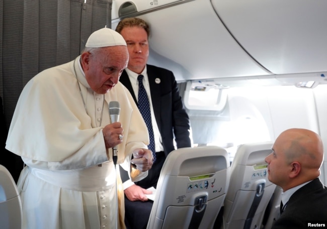 Pope Francis speaks with reporters on his flight back from Tallinn, Estonia, after the final leg of his visit to the Baltic states, Sept. 25, 2018.