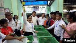 An Union Election Commission staff counts votes at a polling station during for the by-election in Yangon, Myanmar, Nov. 3, 2018. 