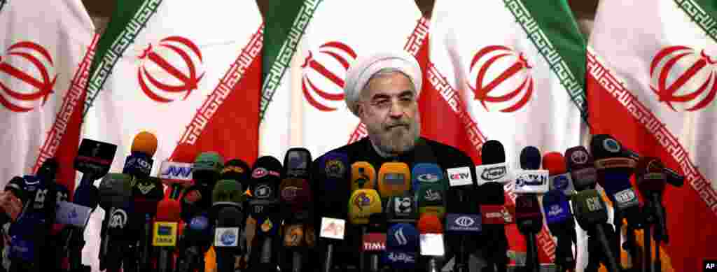 Iranian newly elected President Hasan Rowhani listens during a press conference in Tehran.