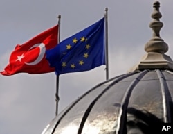 FILE - Flags of Turkey and the European Union are seen over the dome of a mosque in Istanbul, Turkey, Oct. 4, 2005.