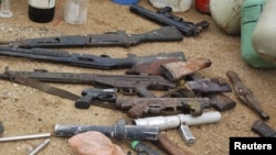 Confiscated weapons are displayed after a military raid on a hideout of suspected Islamist Boko Haram members in Nigeria's northern city of Kano August 11, 2012.
