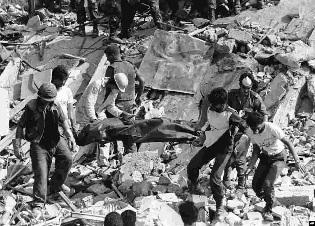 FILE - Rescue workers are shown carrying the body of a U.S. Marine killed by the bombing of the Marine barracks in Beirut, Lebanon, Oct. 24, 1983.