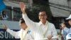 FILE - Opposition leader Sam Rainsy (white shirt, right), and deputy opposition leader Kem Sokha (left) wave to people watching the march, Phnom Penh, Cambodia. (Robert Carmichael/VOA).