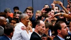 Former President Barack Obama greets supporters as he campaigns in support of California congressional candidates, Sept. 8, 2018, in Anaheim, Calif. 