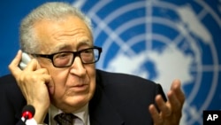 U.N. mediator Lakhdar Brahimi, left, gestures during a press briefing at the United Nations headquarters in Geneva, Feb 11, 2014.